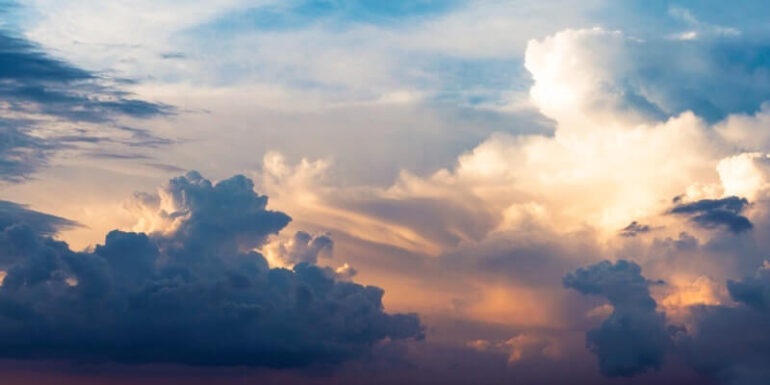 A cloud with the sun shining out behind it.