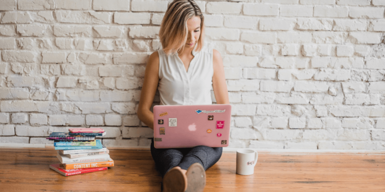 A woman using a laptop.